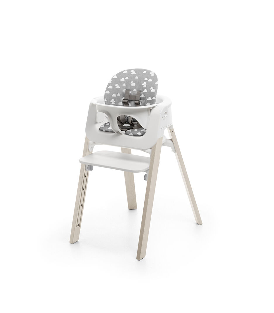 Stokke® Steps™ Whitewash with Baby Set and Grey Clouds Cushion.